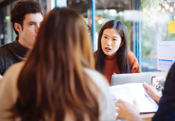 Student smiling with a laptop in class