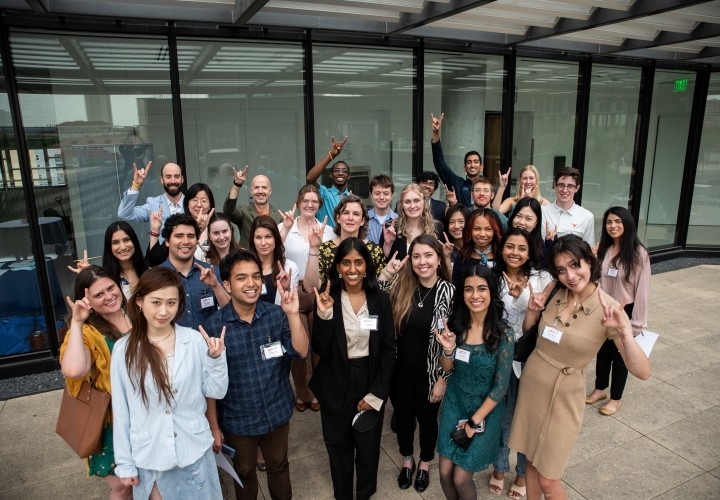 Group of students giving Hook 'Em Horns
