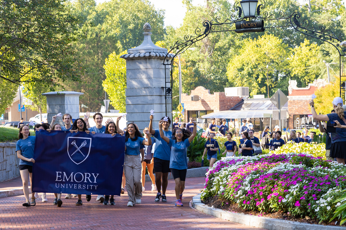 image of students walking under gate