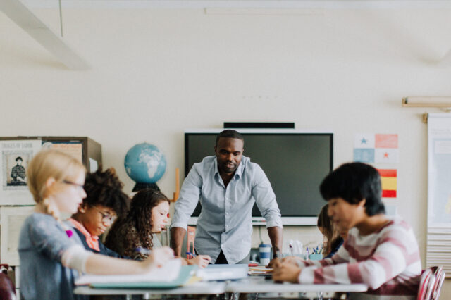 Teacher working with students in a classroom