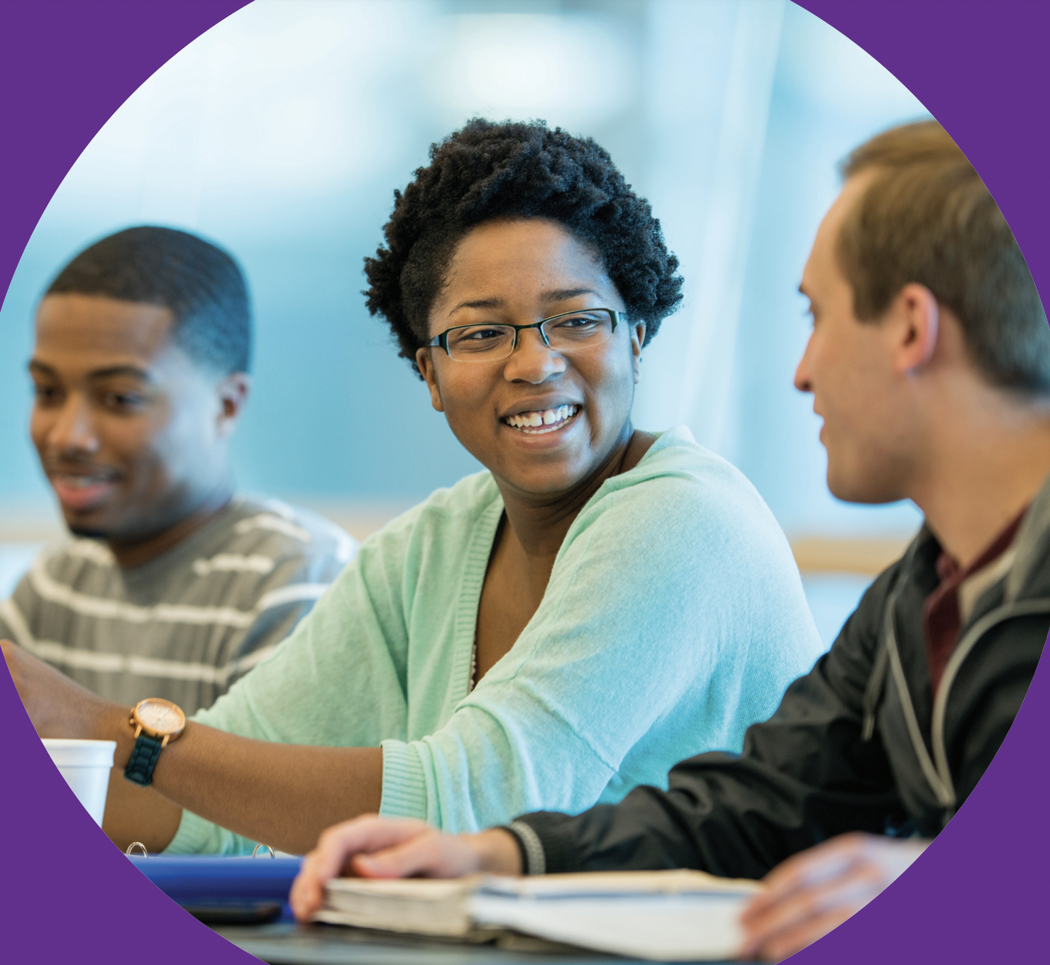three students smiling, two looking at each other