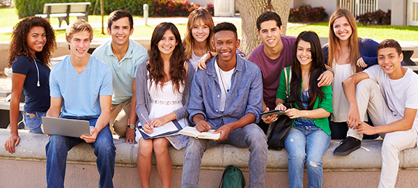 high school students seated at a fountain